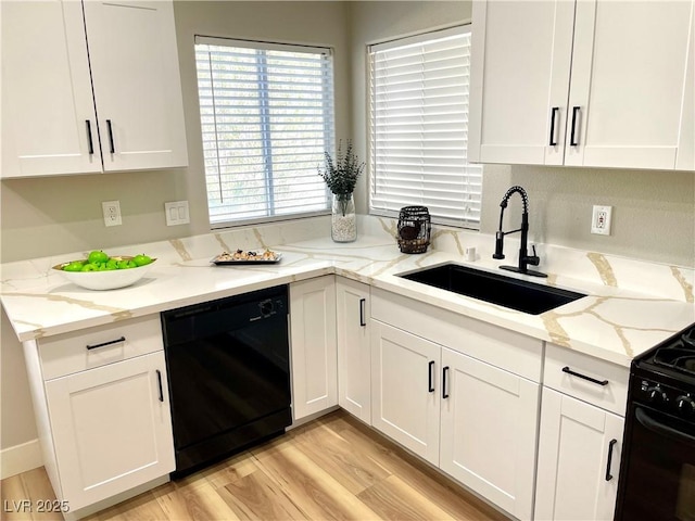 kitchen featuring black appliances, a sink, and white cabinetry