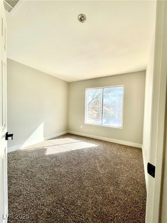 carpeted empty room with visible vents and baseboards