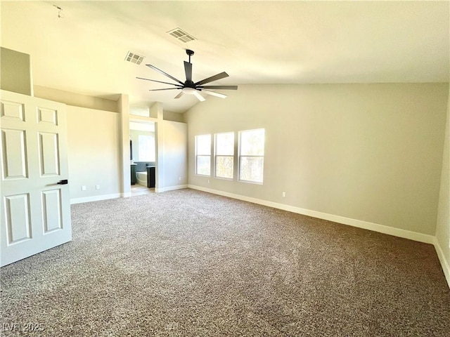 carpeted empty room with visible vents, vaulted ceiling, baseboards, and ceiling fan