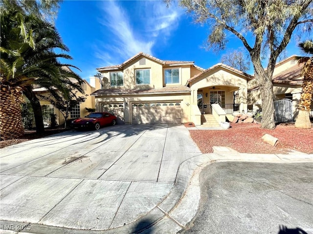 mediterranean / spanish-style house featuring a garage, covered porch, a tile roof, concrete driveway, and stucco siding