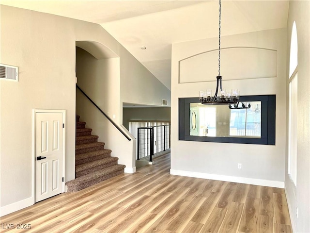 interior space featuring visible vents, stairway, baseboards, and wood finished floors