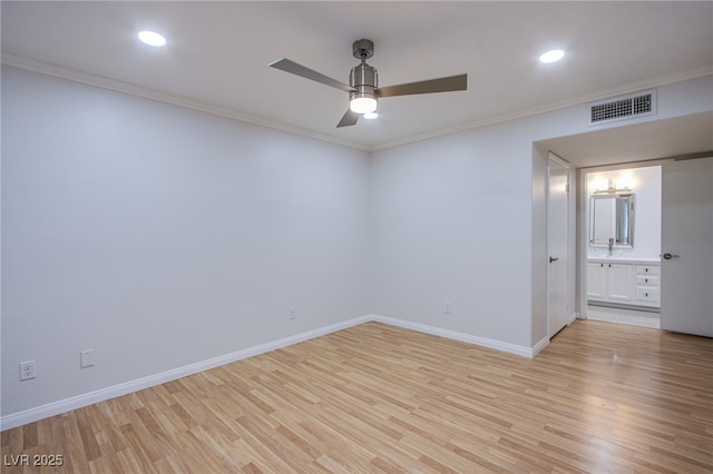 empty room with visible vents, light wood-style floors, ornamental molding, ceiling fan, and baseboards