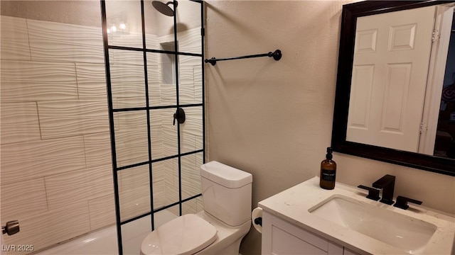 full bath with toilet, a textured wall, and vanity