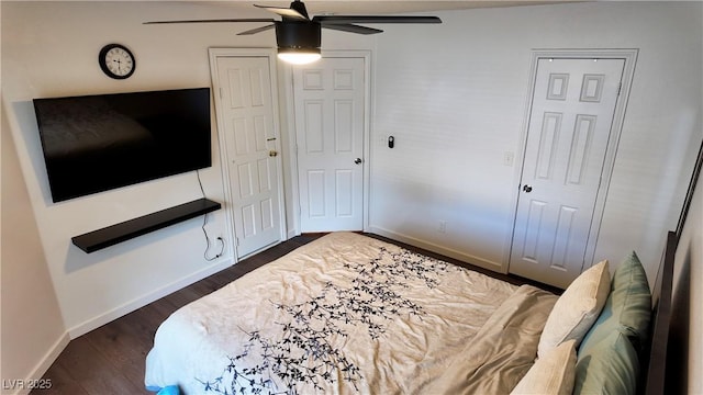 bedroom featuring ceiling fan, dark wood finished floors, and baseboards