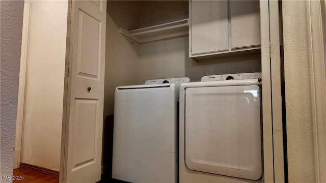 laundry area featuring washing machine and dryer and cabinet space