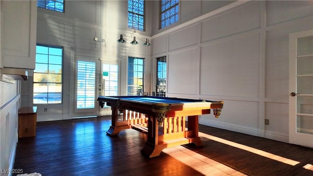 recreation room with a decorative wall, pool table, a high ceiling, dark wood-style flooring, and french doors