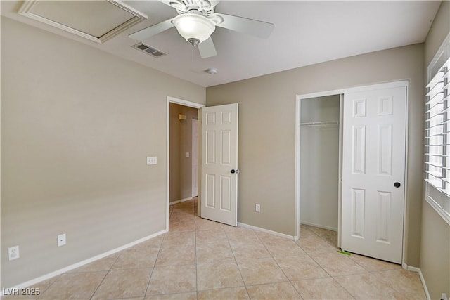 unfurnished bedroom featuring baseboards, visible vents, ceiling fan, a closet, and light tile patterned flooring