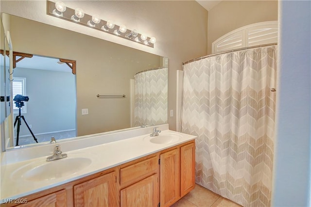 bathroom featuring tile patterned flooring, a sink, and double vanity