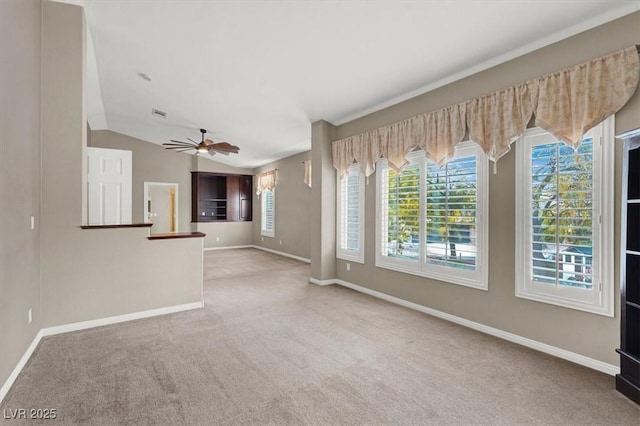 unfurnished living room featuring lofted ceiling, carpet, a ceiling fan, and baseboards