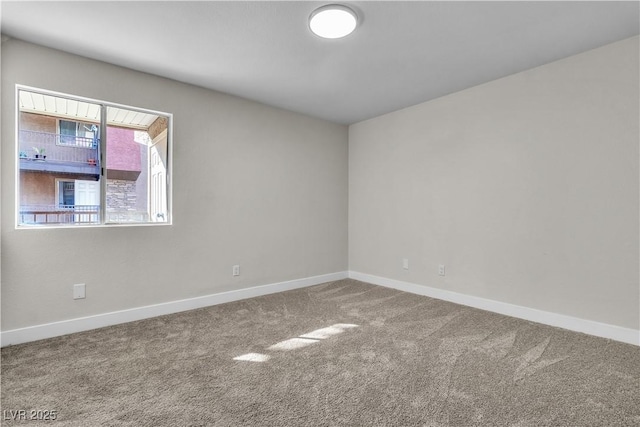 carpeted empty room with baseboards