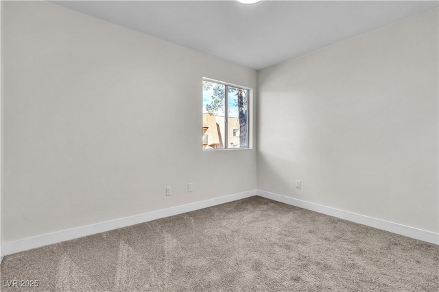 empty room featuring carpet floors and baseboards