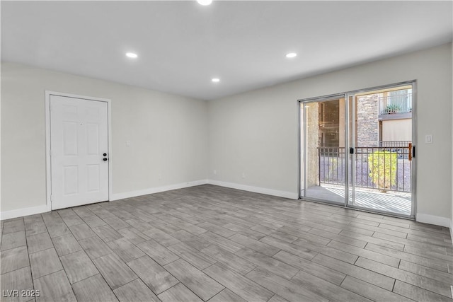 empty room with light wood-style floors, baseboards, and recessed lighting