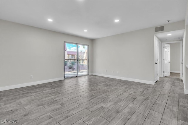 spare room with wood finish floors, recessed lighting, visible vents, and baseboards