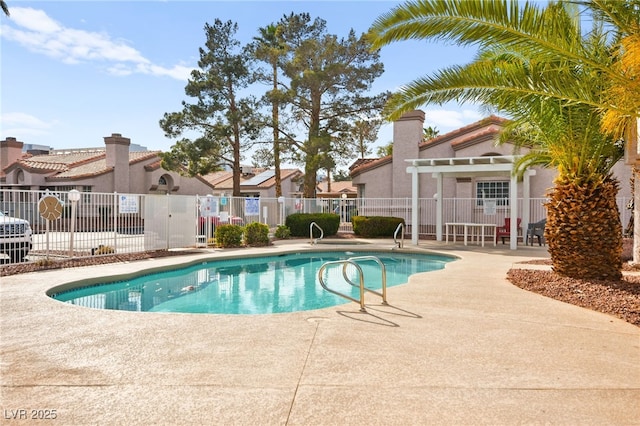 community pool featuring a patio area, a residential view, and fence