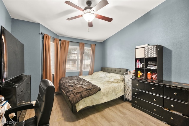 bedroom featuring light wood-type flooring and a ceiling fan