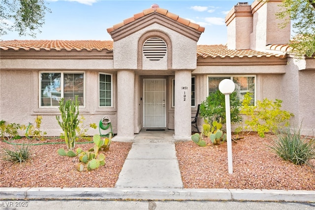 view of front of property featuring a tile roof and stucco siding