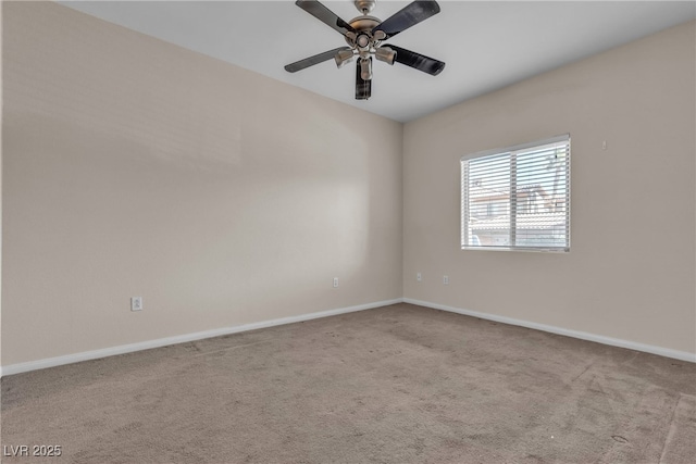 spare room featuring light carpet, baseboards, and a ceiling fan