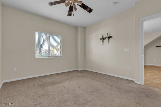 unfurnished room featuring ceiling fan, baseboards, and light colored carpet