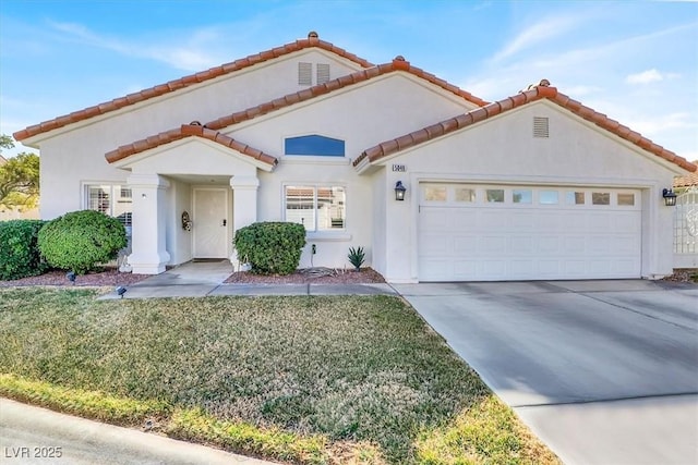 mediterranean / spanish house featuring a garage, concrete driveway, a tile roof, and stucco siding