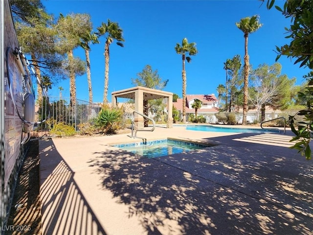 community pool featuring fence and a patio