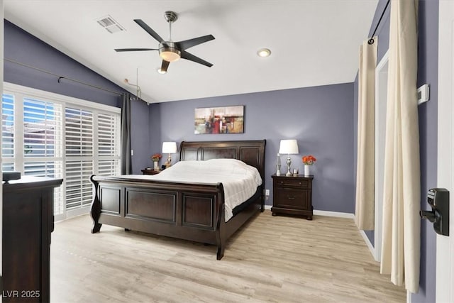 bedroom featuring vaulted ceiling, light wood-type flooring, visible vents, and baseboards