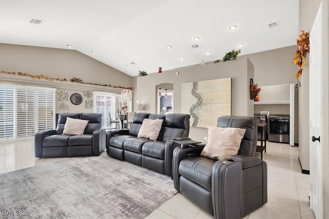 living room featuring light tile patterned flooring, vaulted ceiling, and visible vents