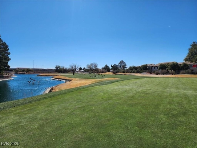 view of property's community featuring a water view and a yard