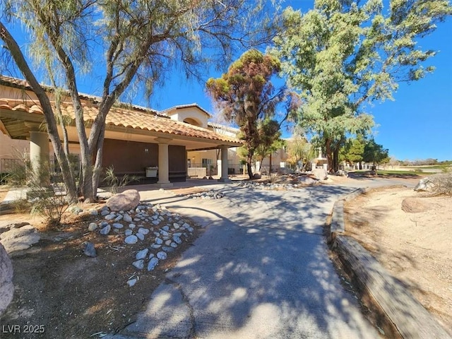 view of front of home with a tiled roof and stucco siding