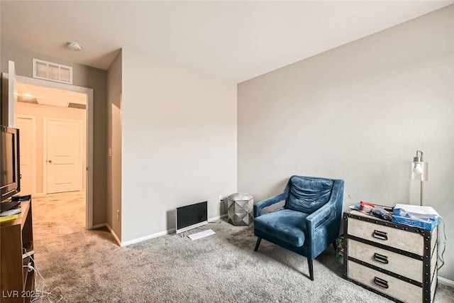 sitting room featuring carpet floors, visible vents, and baseboards