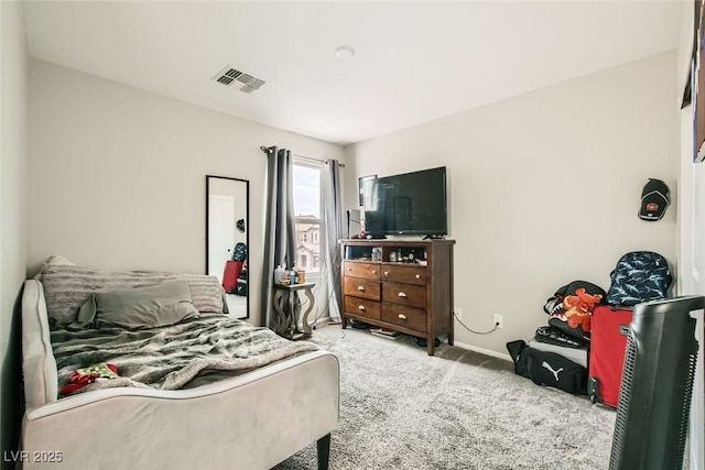 bedroom with visible vents, light carpet, and baseboards