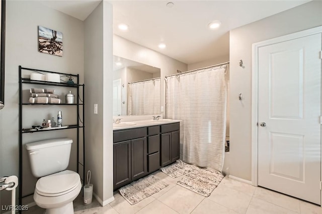 bathroom with a shower with shower curtain, a sink, toilet, and double vanity