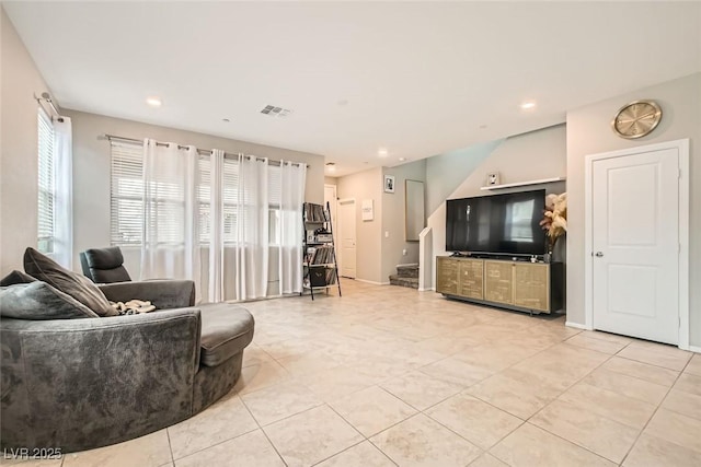 living room with recessed lighting, light tile patterned floors, baseboards, and stairs