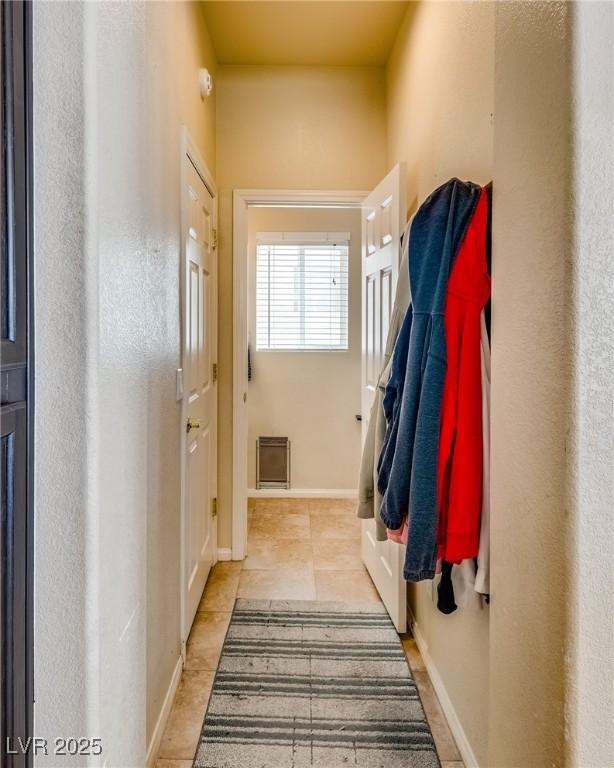 entryway featuring light tile patterned floors and baseboards