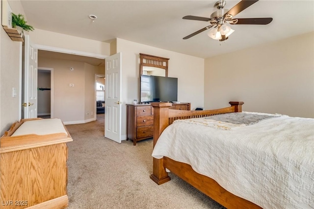 bedroom with light colored carpet, ceiling fan, and baseboards