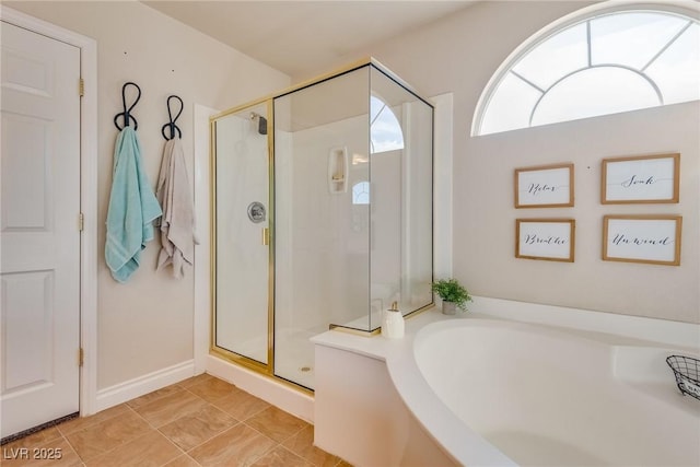 full bath with a garden tub and a shower stall