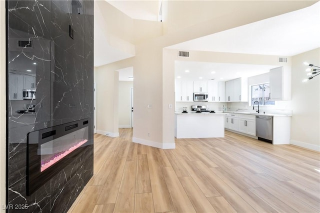 interior space featuring white cabinets, visible vents, appliances with stainless steel finishes, and light countertops