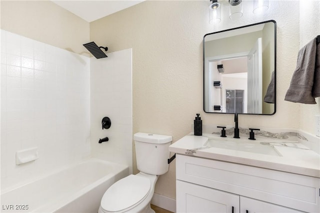 bathroom featuring toilet, a textured wall, vanity, and bathing tub / shower combination