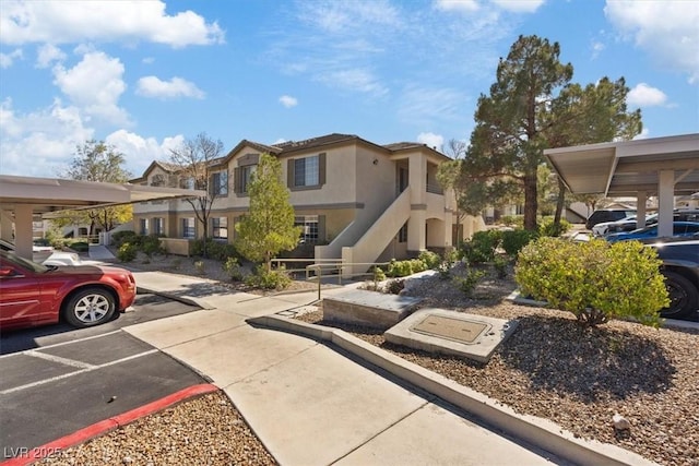 exterior space with a residential view and covered and uncovered parking