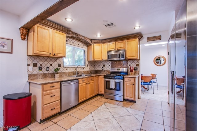 kitchen featuring light tile patterned floors, a sink, visible vents, light countertops, and appliances with stainless steel finishes