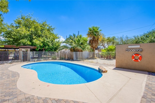 view of swimming pool featuring a fenced in pool, a patio area, and fence