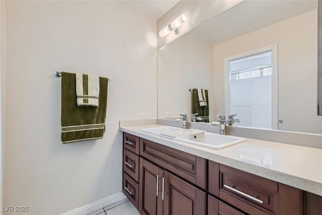 bathroom with tile patterned floors, baseboards, and vanity