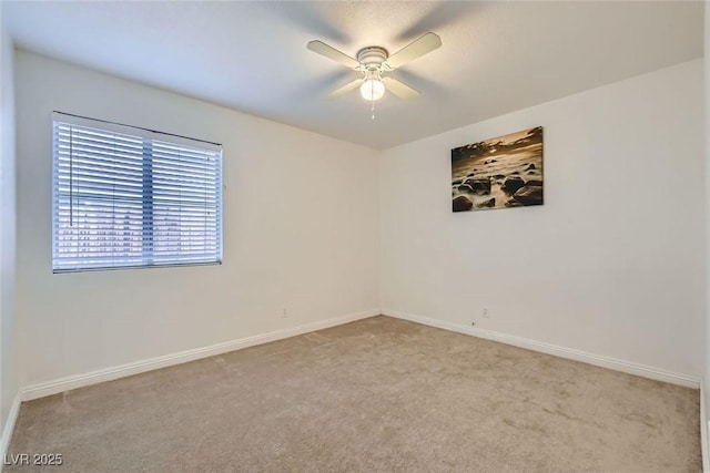 unfurnished room with carpet floors, a ceiling fan, and baseboards