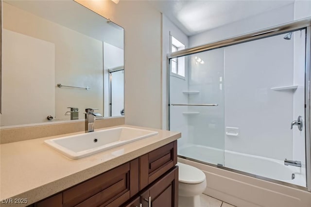 full bath featuring shower / bath combination with glass door, vanity, and toilet