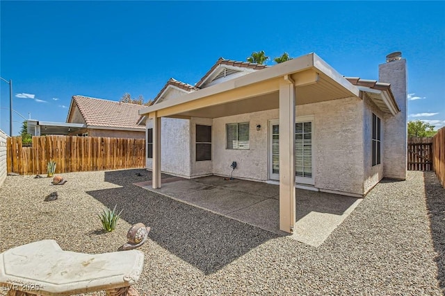 back of house featuring a patio area, a fenced backyard, and stucco siding