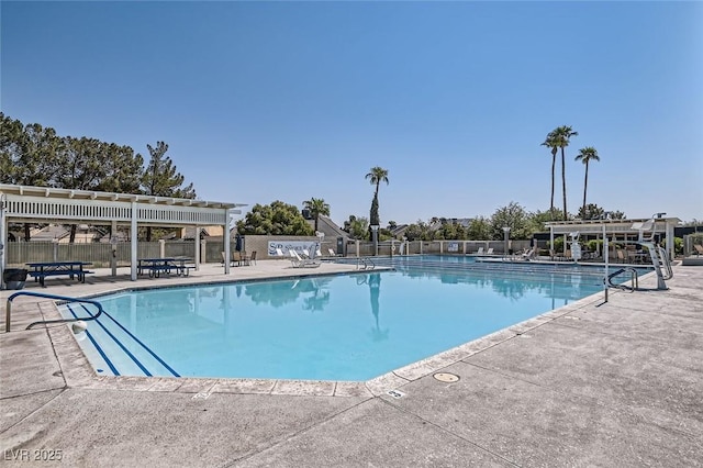 pool with a patio area, fence, and a pergola