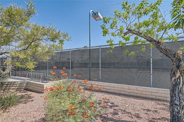 view of sport court featuring fence