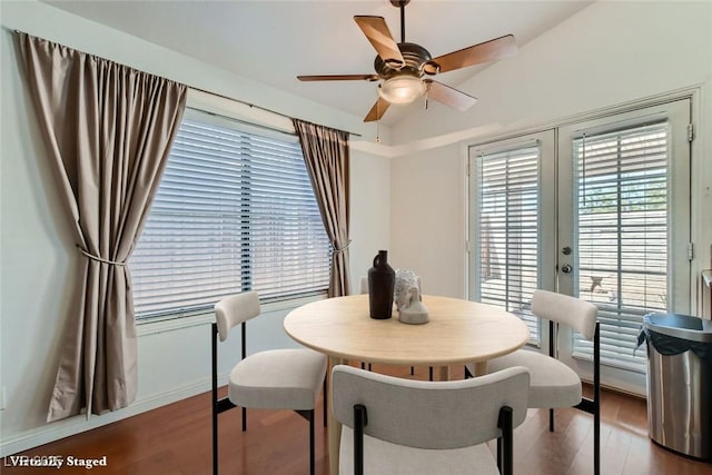 dining area featuring a ceiling fan, french doors, and wood finished floors