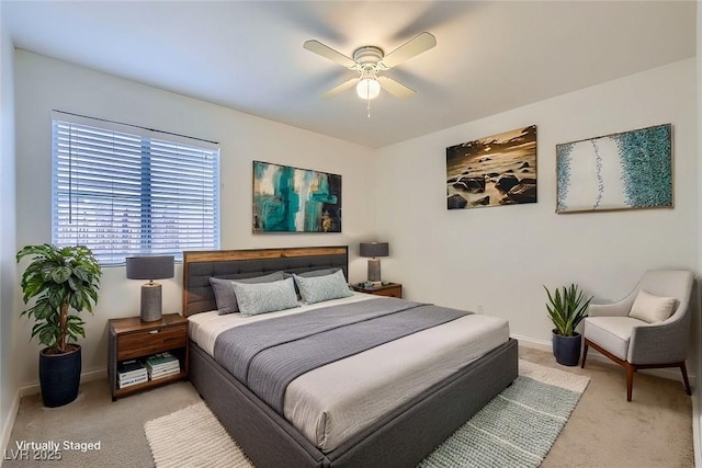 bedroom with baseboards, a ceiling fan, and light colored carpet