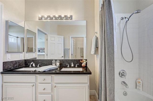 full bathroom featuring double vanity, shower / tub combo, and a sink