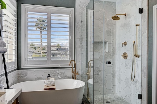 full bath featuring a stall shower, a freestanding tub, and tile walls